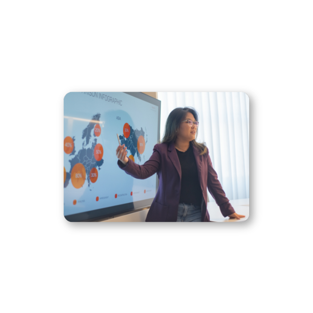 Advanced Visualization for Deeper Insights hero in colour Woman with glasses pointing at a digital map of the world with percentages on it