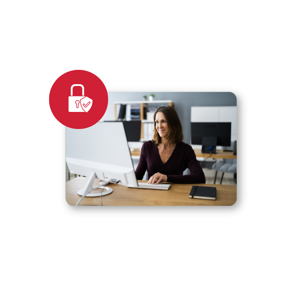 Enhancing Data Security and Compliance for Your Business hero in colour Woman working on desktop computer with lock logo in front