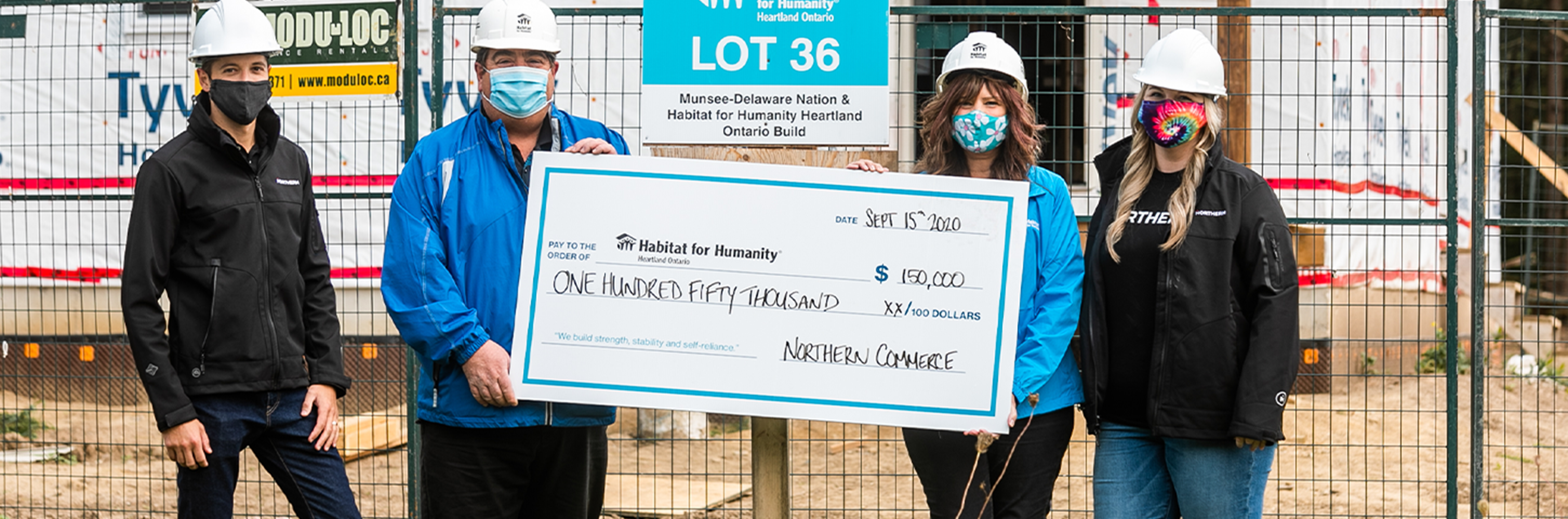 Habitat for Humanity builders with large cheque