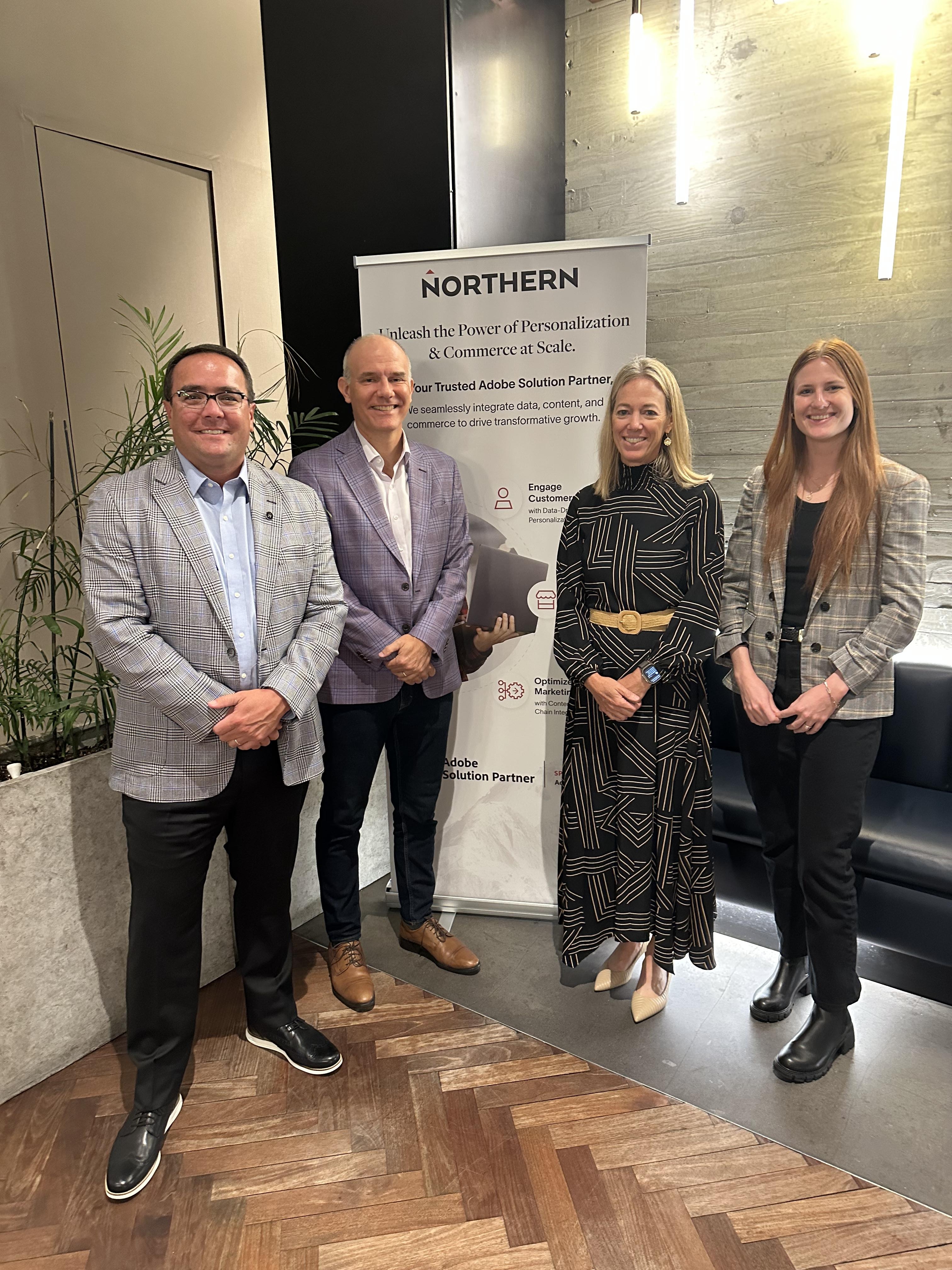 Greta Wilson, Chief Marketing Officer at Pitney Bowes, with Northern CEO Mark Kelley and Beau Brewer, VP Content Supply Chain, in front of a Northern banner.