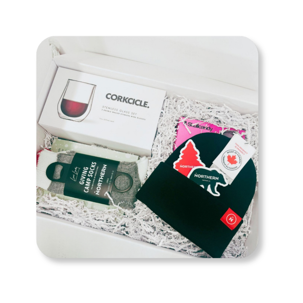 Northern and Klaviyo gift box, open to show glassware, earbuds, socks, a toque and stickers.