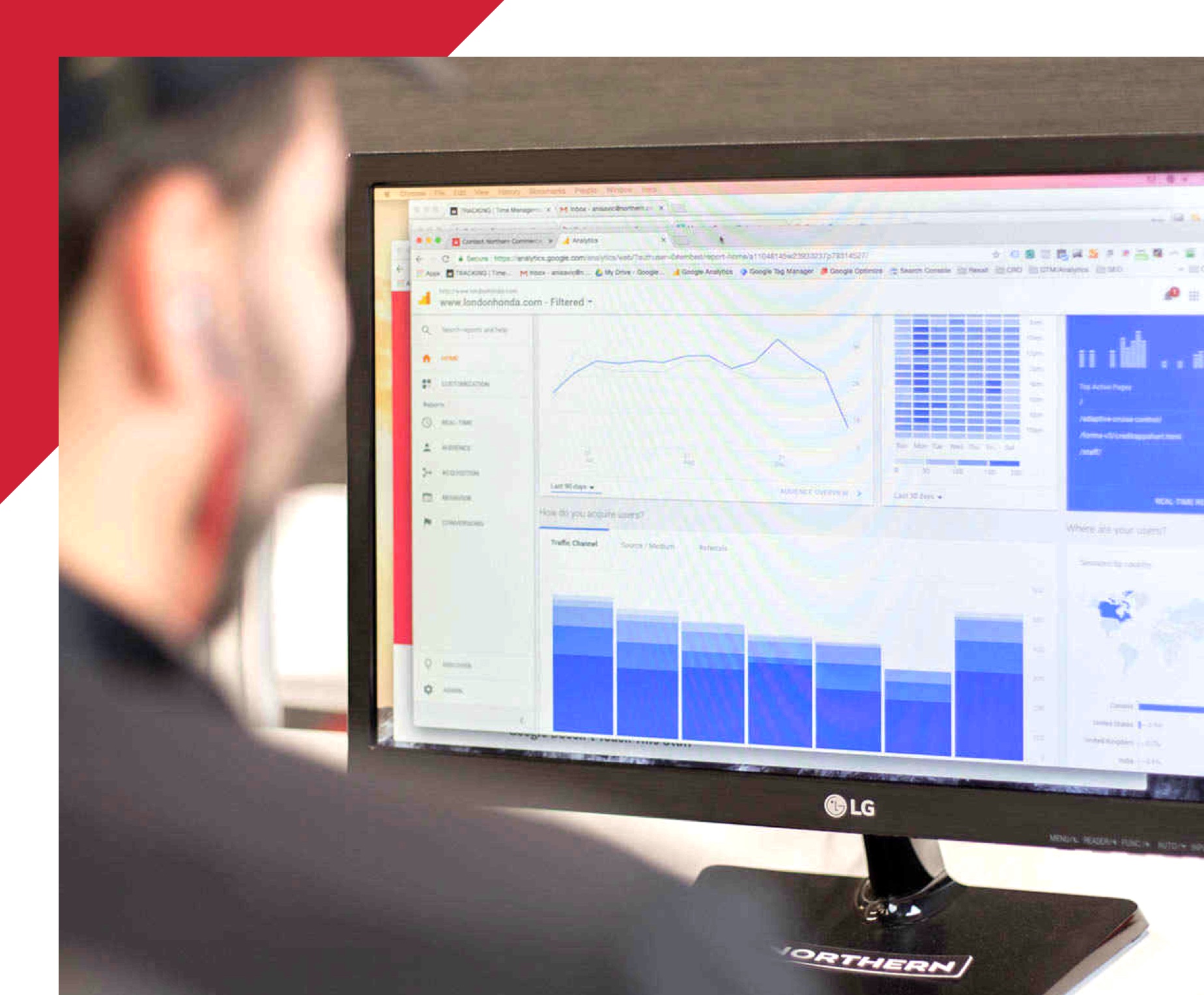 view over the shoulder of a man working on a computer showing analytics data