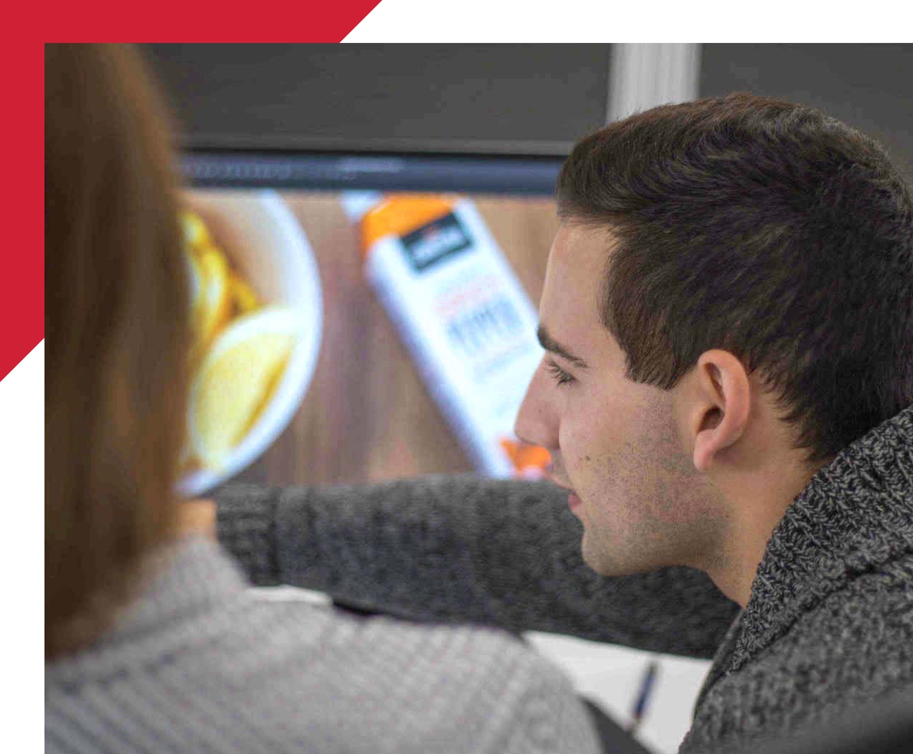 man and woman looking and pointing at a computer screen
