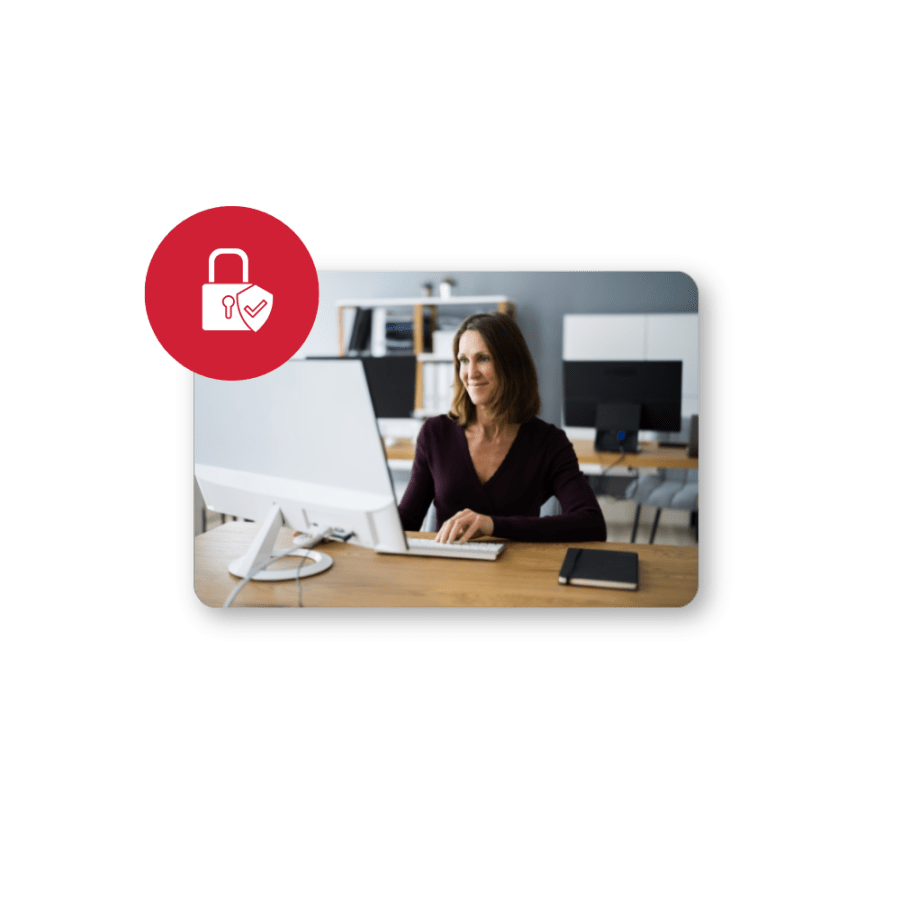 Woman working on desktop computer with lock logo in front