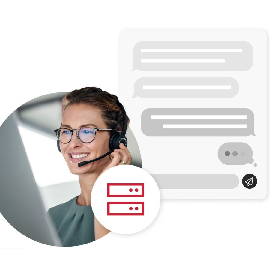 Customer support worker with handsfree mic working on computer next to chat box bubble