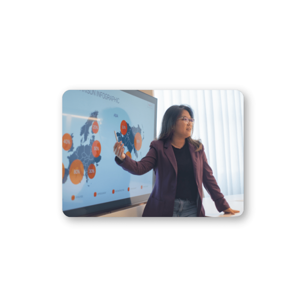 Woman with glasses pointing at a digital map of the world with percentages on it 