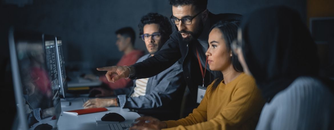 Teacher helps students with project and advising on their work.