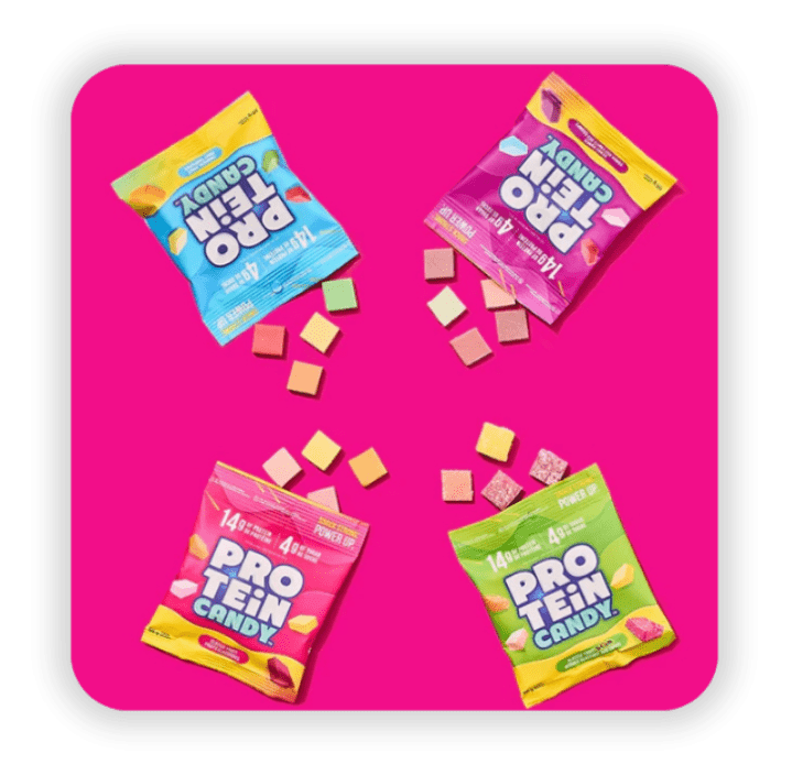 Four pouches of protein candy on a pink background