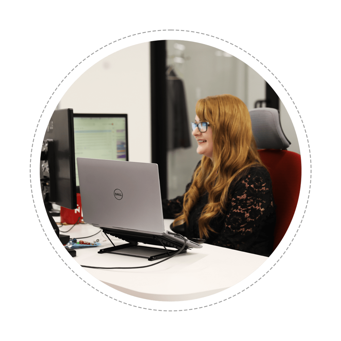 Woman smiling while looking at computer monitor