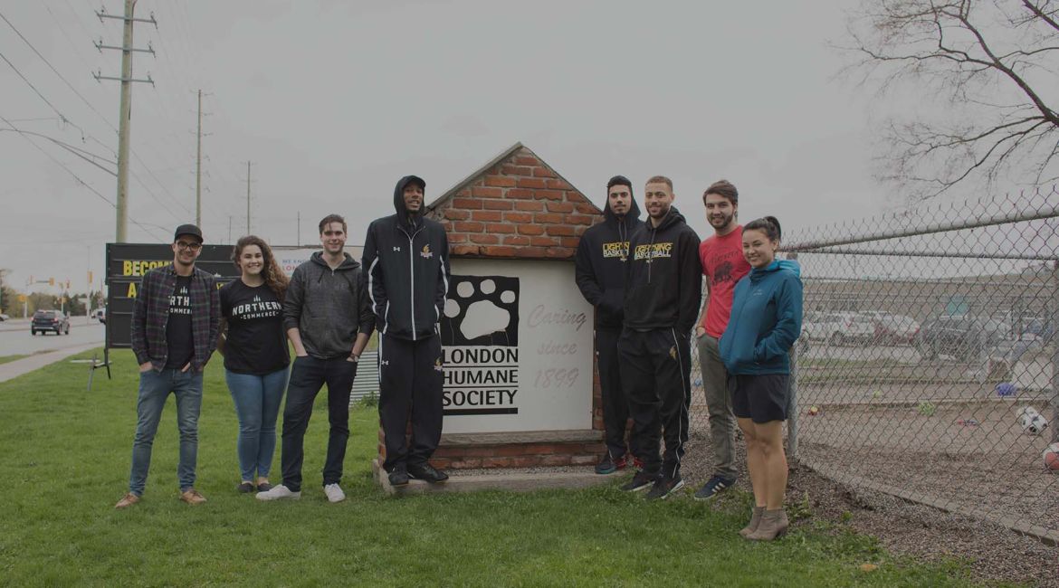 Northern team members in front of London Humane Society sign