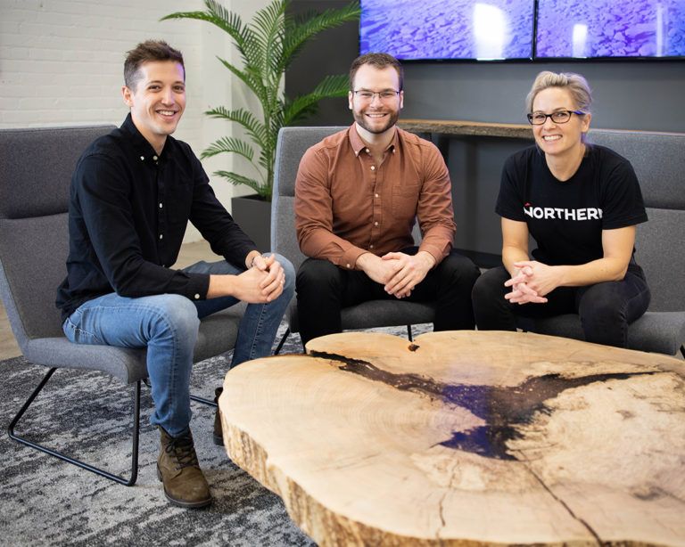 Northern team members sitting at coffee table