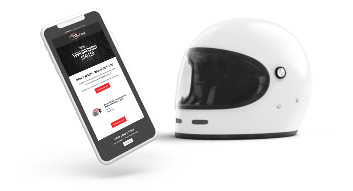 Phone with GP Bikes email beside motorcycle helmet