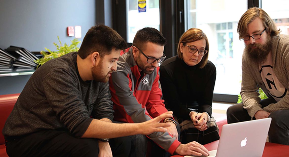 People gathered around a computer