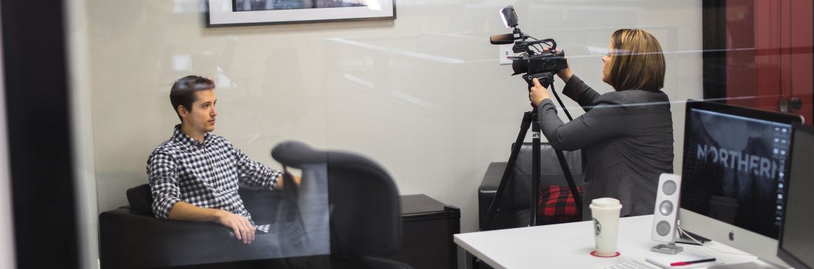 Man being filmed in office