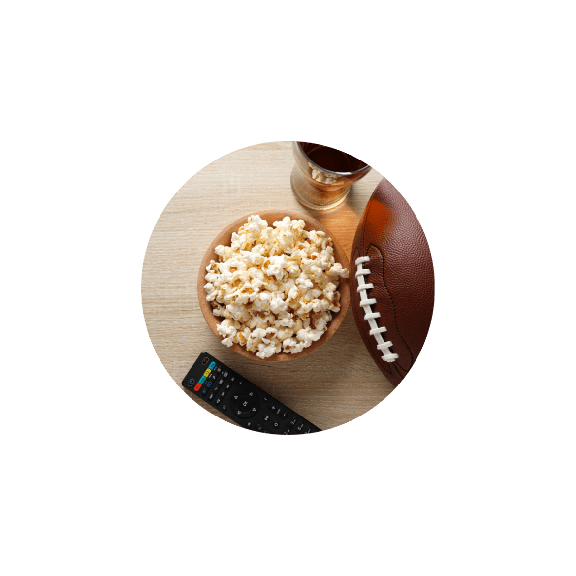 A bowl of popcorn, a football, and a television remote