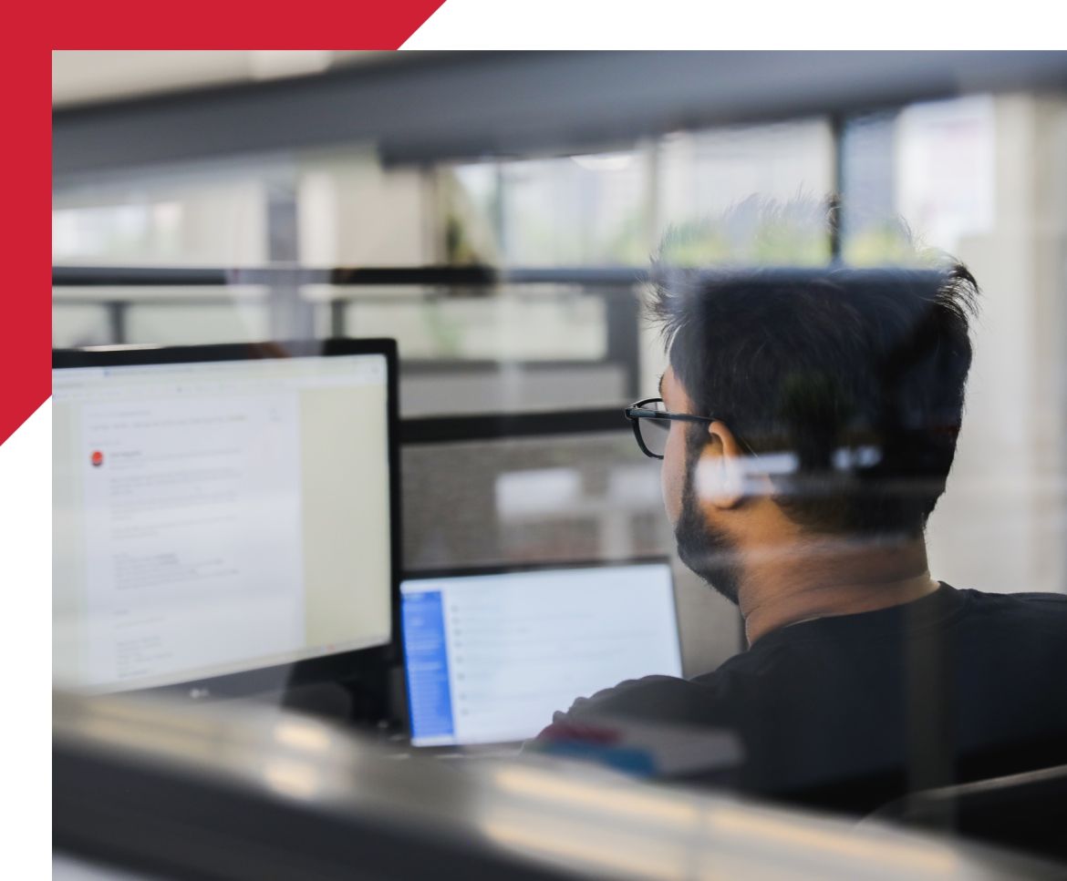 view over the shoulder of a man working on a computer
