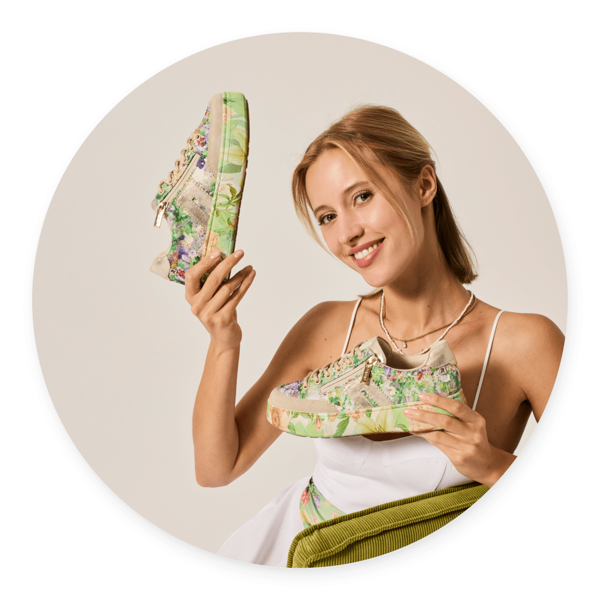 Woman holding a pair of floral print Quarks sneakers