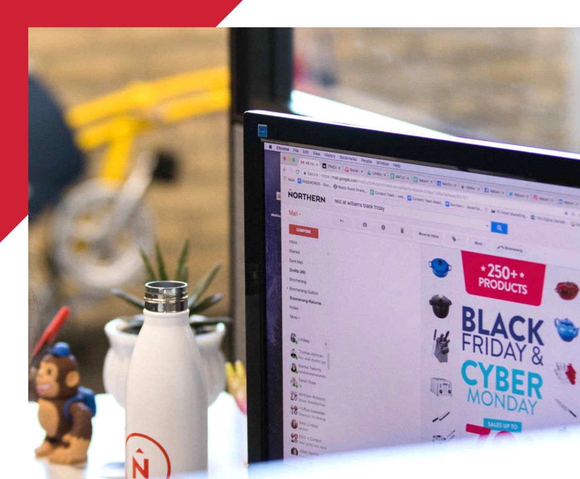 view of a computer screen on a desk displaying a marketing email
