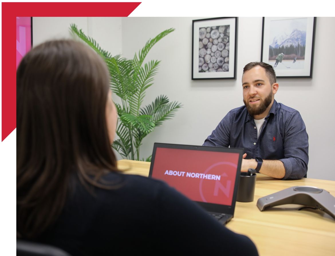people sitting at a table conducting an interview