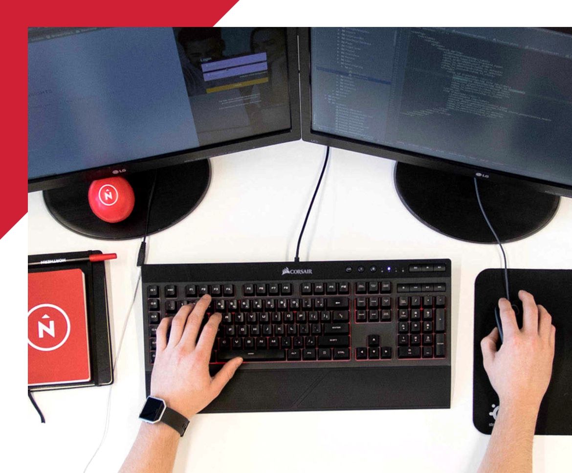 top down view of man working on dual monitor computer set up