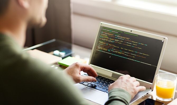 Developer coding on laptop