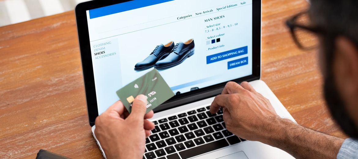 Man purchasing shoes online with credit card