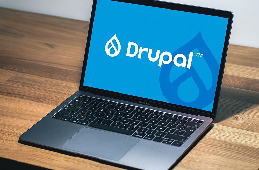 Drupal logo displayed on a laptop.