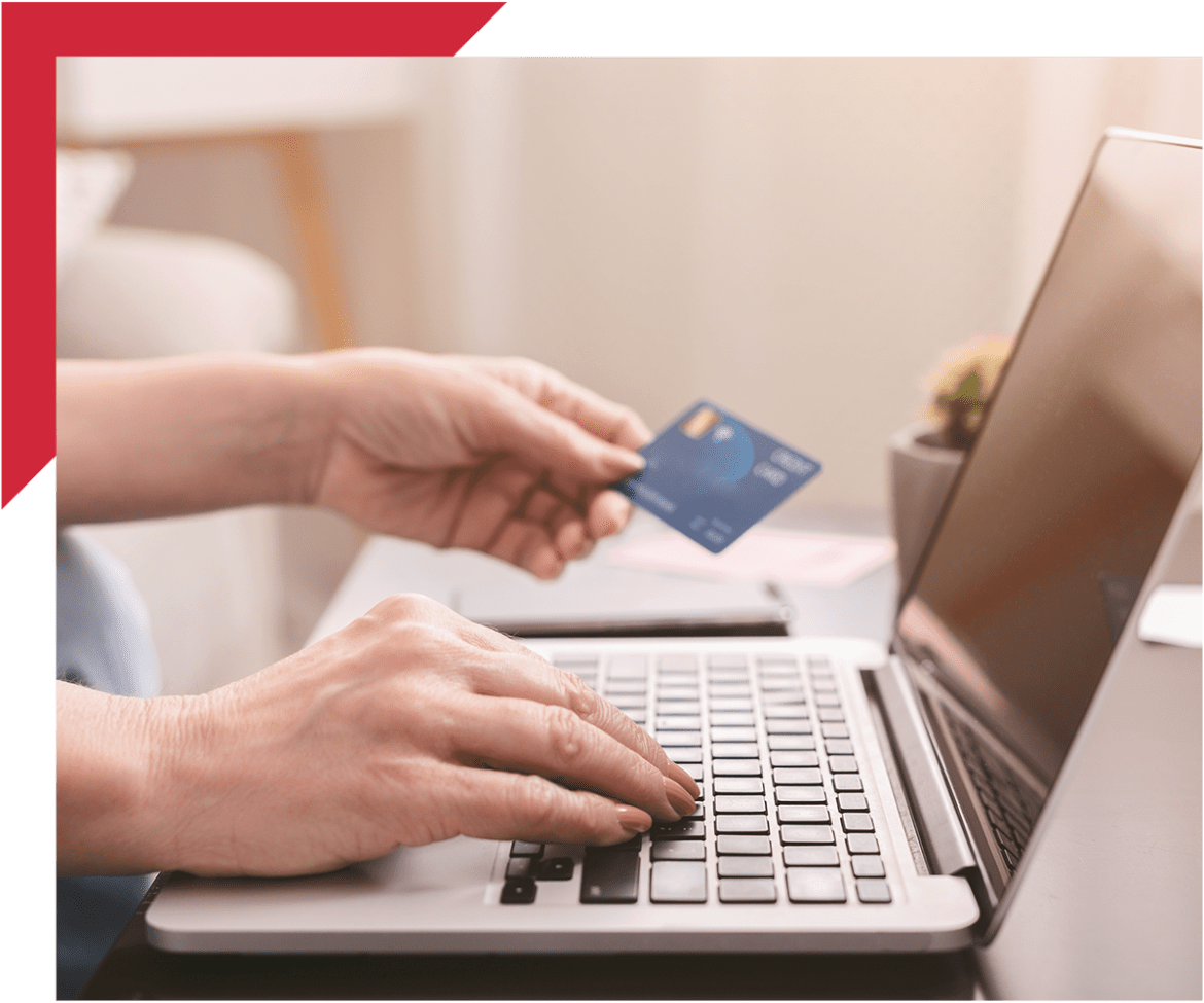 Person paying on computer with credit card