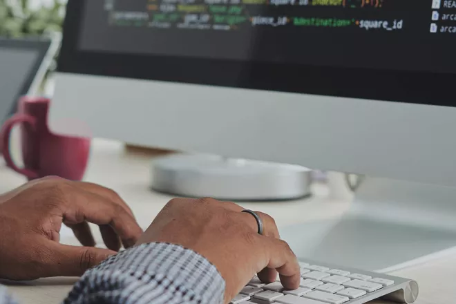 Person coding on a computer