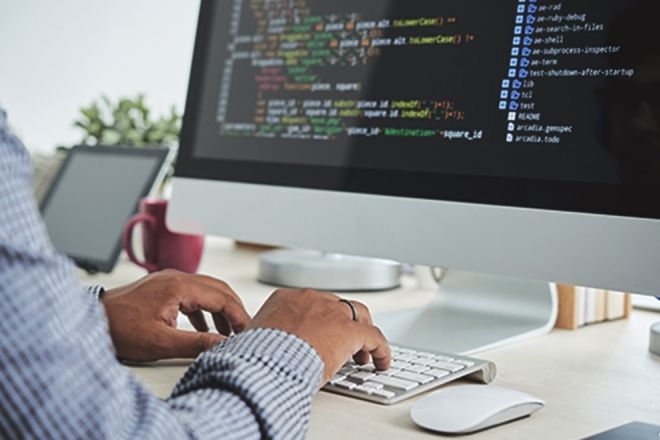 Man typing code on computer