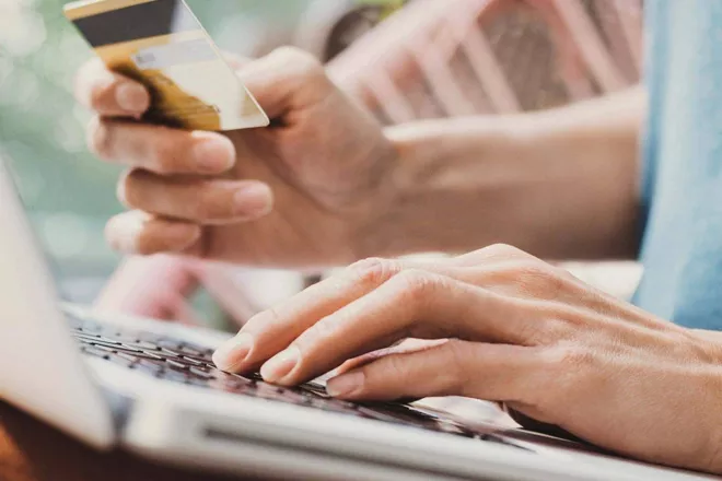 Person using laptop to shop online.