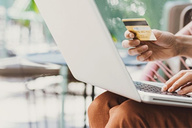 Person using laptop to shop online.