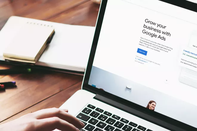 Laptop viewing "grow your business with Google Ads"