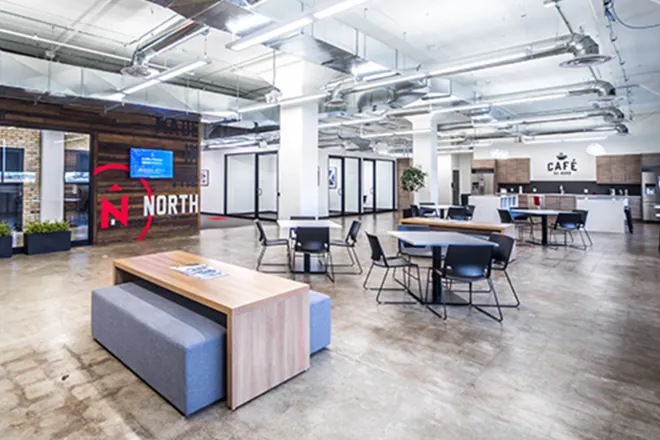 Northern office with tables, chairs, and kitchen