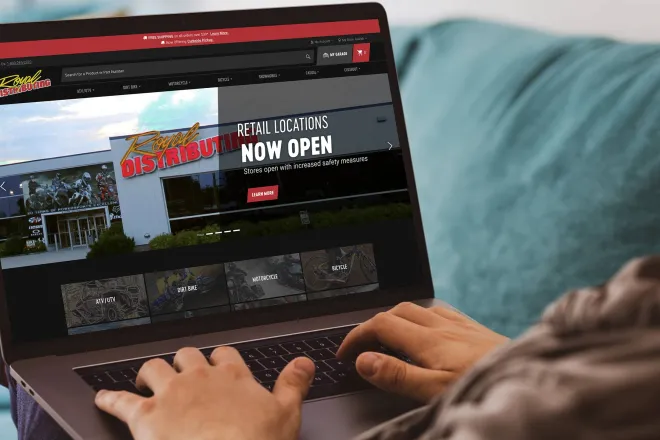 Person looking at Royal Distributing website on laptop