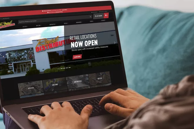 Person looking at Royal Distributing website on laptop