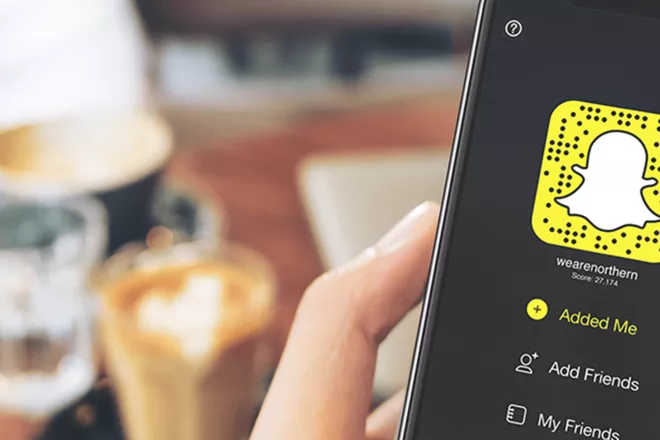 Snapchat app on phone in a hand