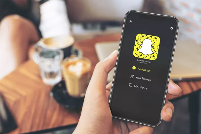 Snapchat app on phone in a hand