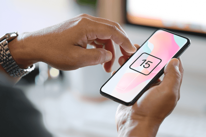Phone displaying number fifteen in someone's hands