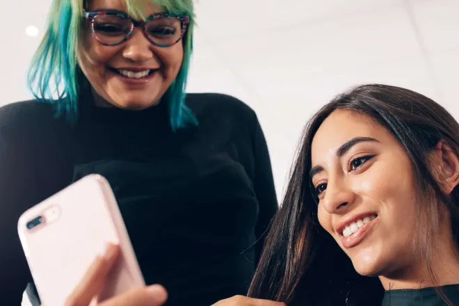 Two people on a mobile device.