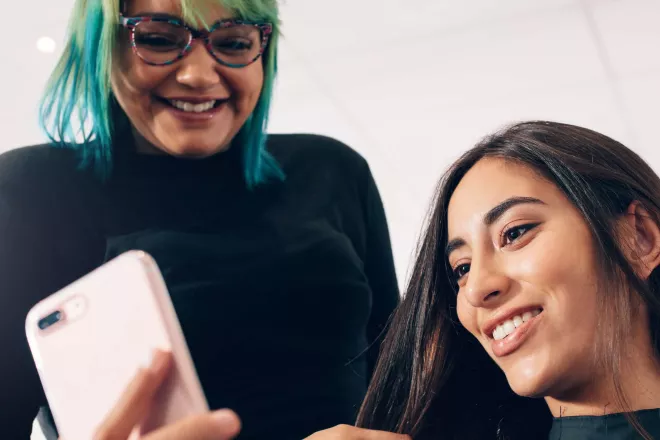 Two people on a mobile device.