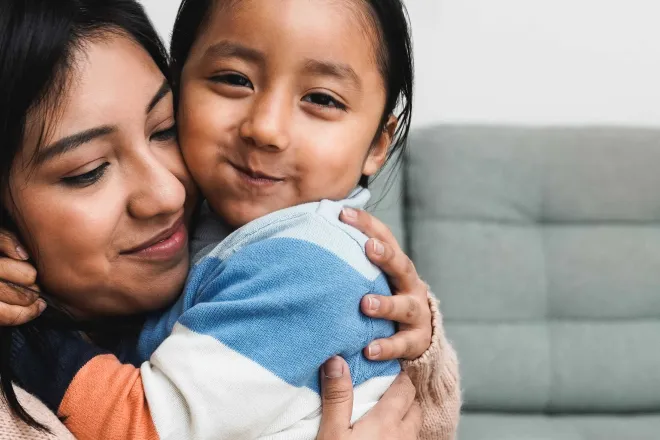 Woman holding child.