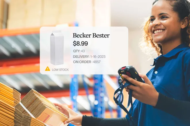 Image of inventory warehouse worker scanning packaging.