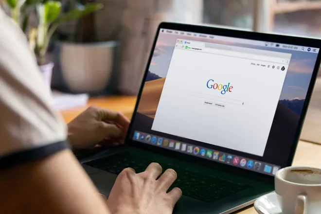 person working on a laptop with google open in browser