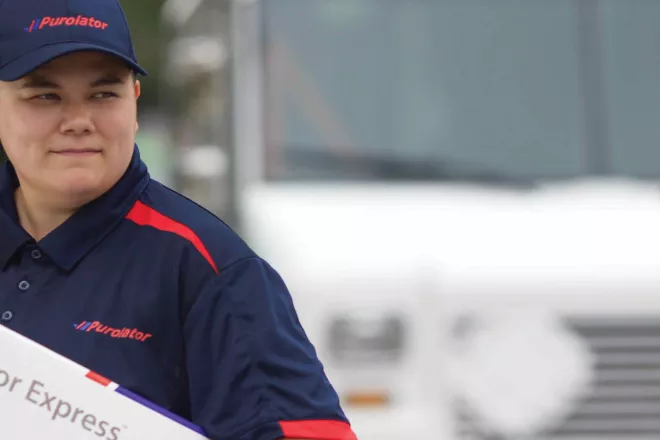 Purolator delivery person delivering a package