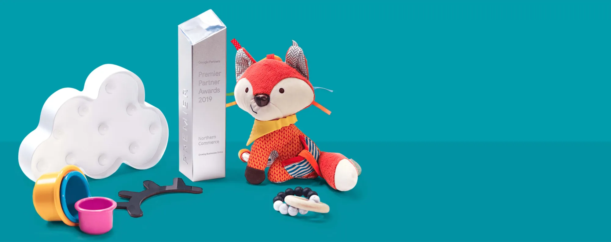 google premier award sitting with toys on a blue background