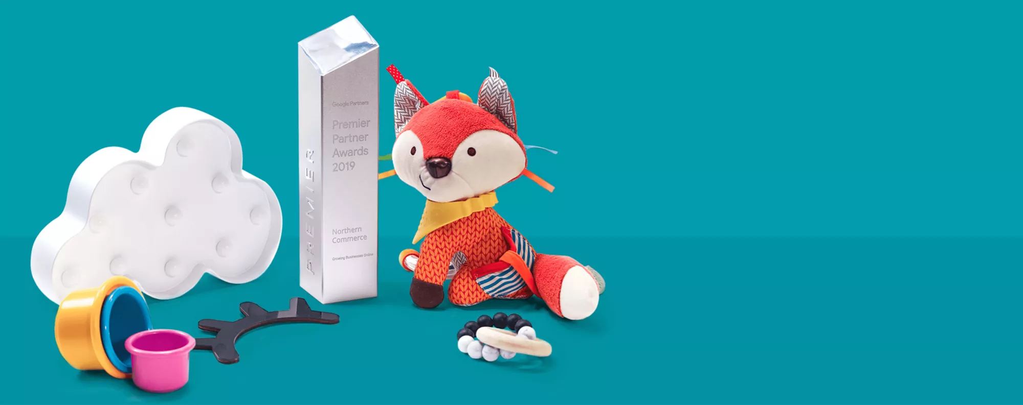 google premier award sitting with toys on a blue background