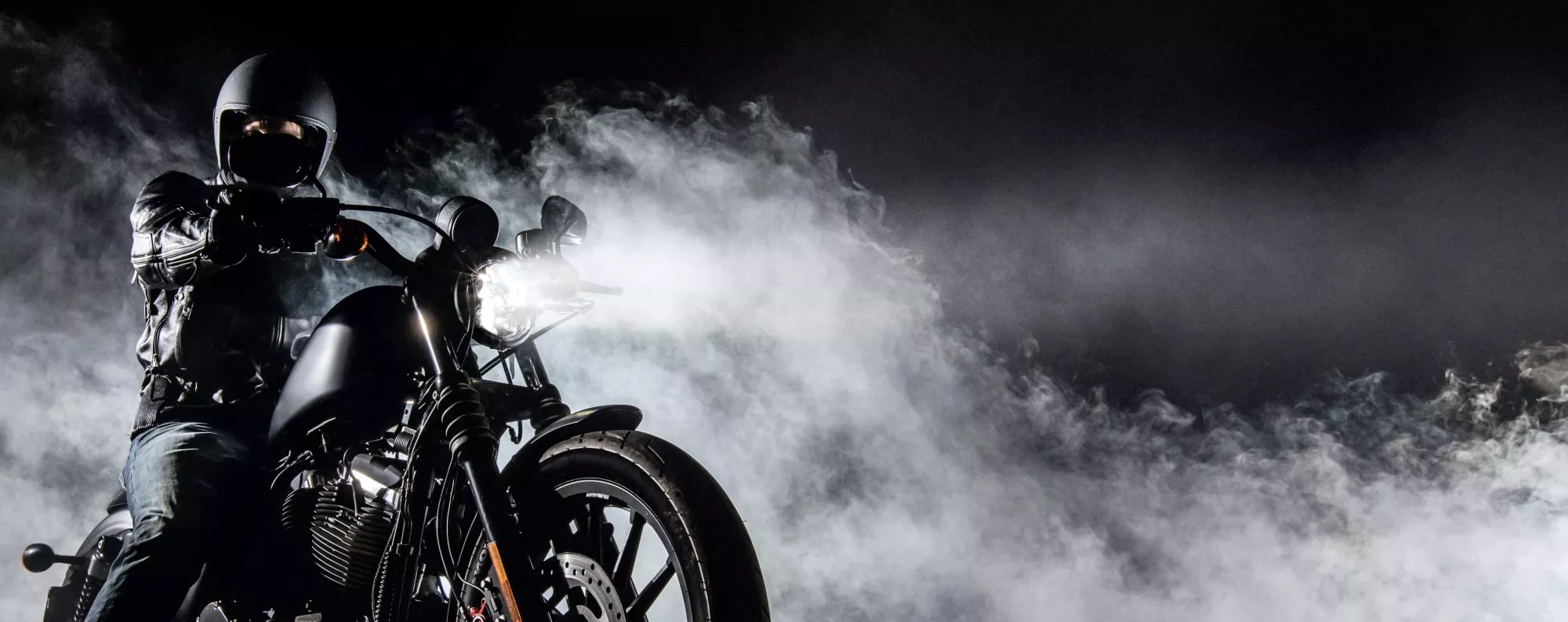 person on motorcycle with smokey background