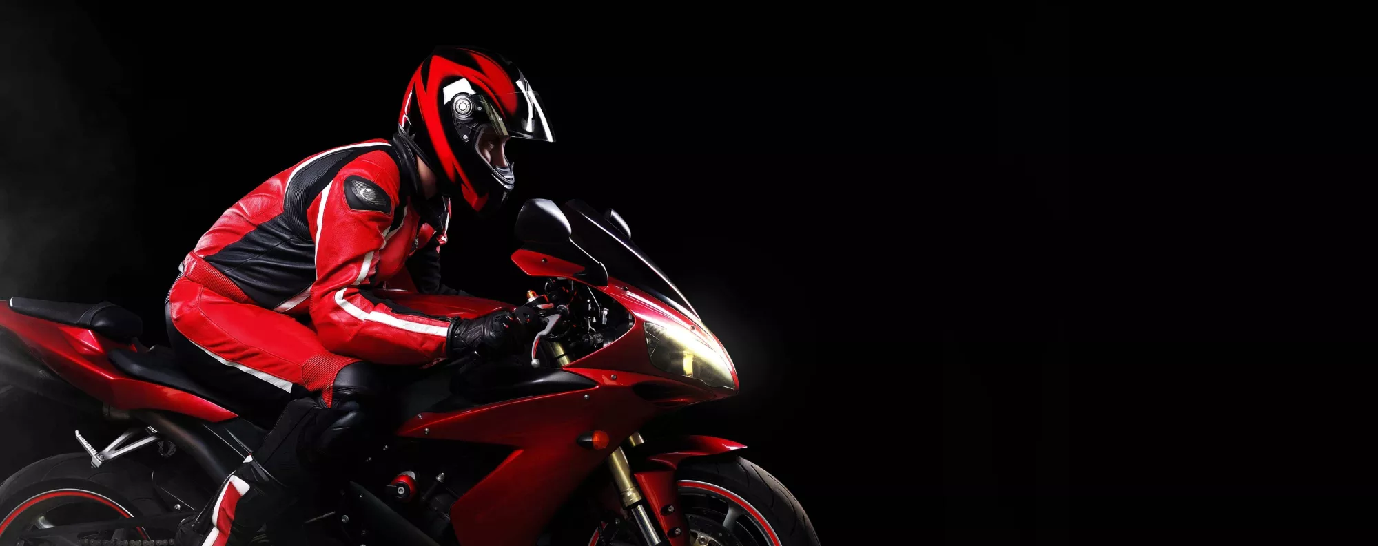 Person riding a red motorcycle