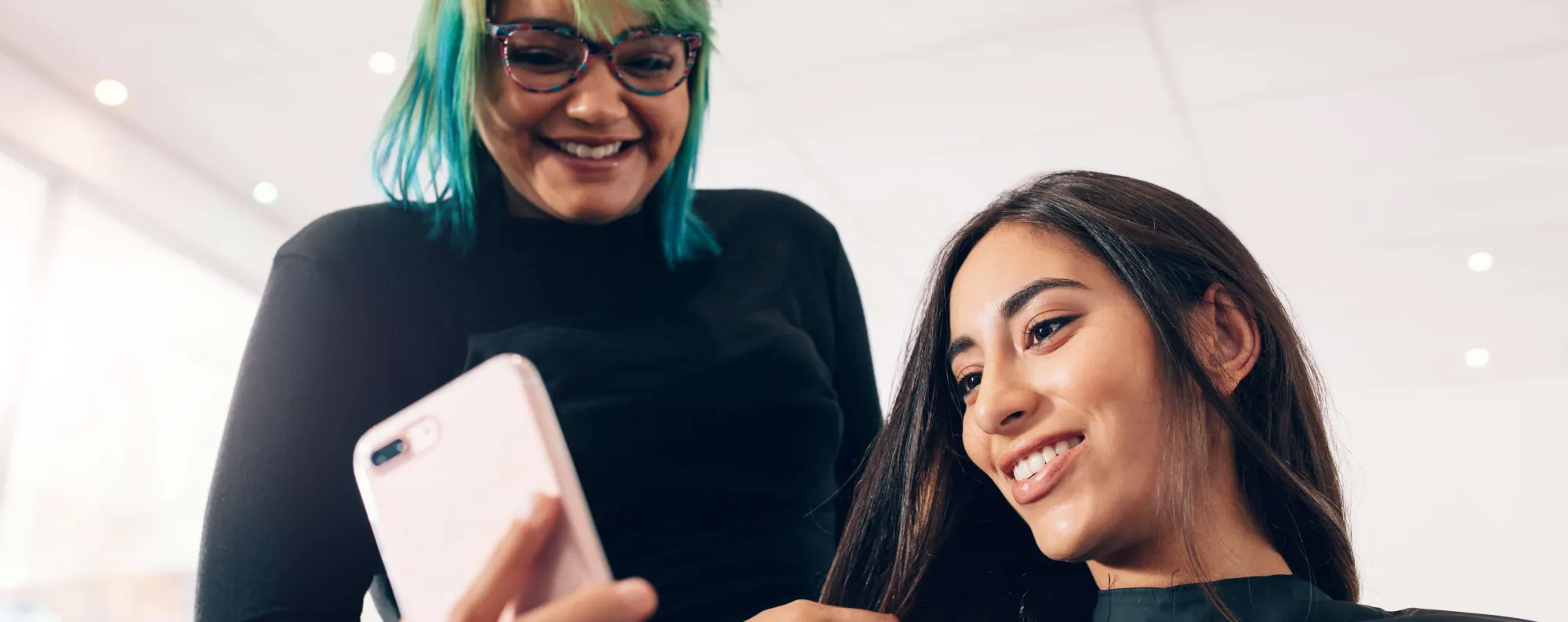 Two people on a mobile device.